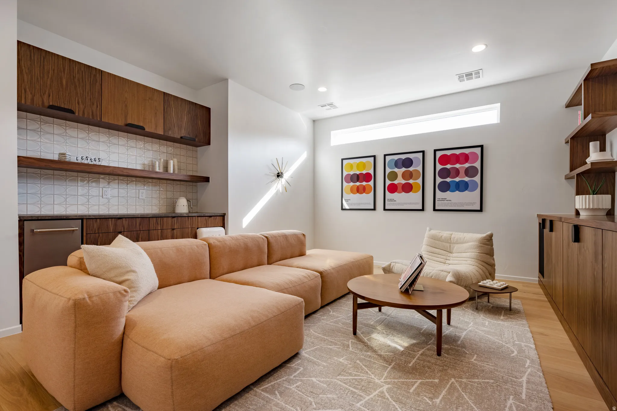 Living room with light wood-style floors and recessed lighting