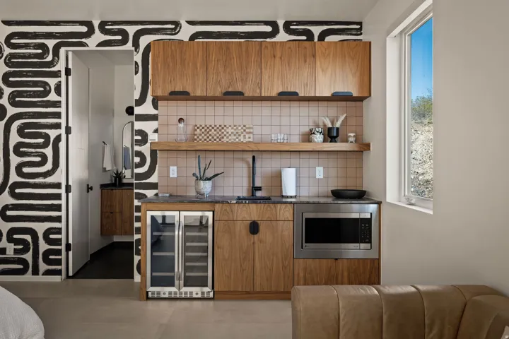 Bar featuring wood finish cabinets, wine cooler, backsplash, open shelves, and stainless steel microwave