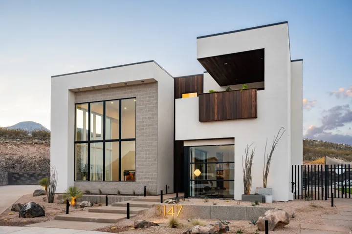 Back of house with stucco siding and a mountain view