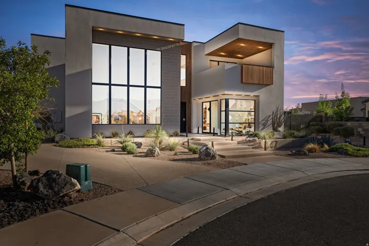 View of front of home featuring stucco siding and a patio area
