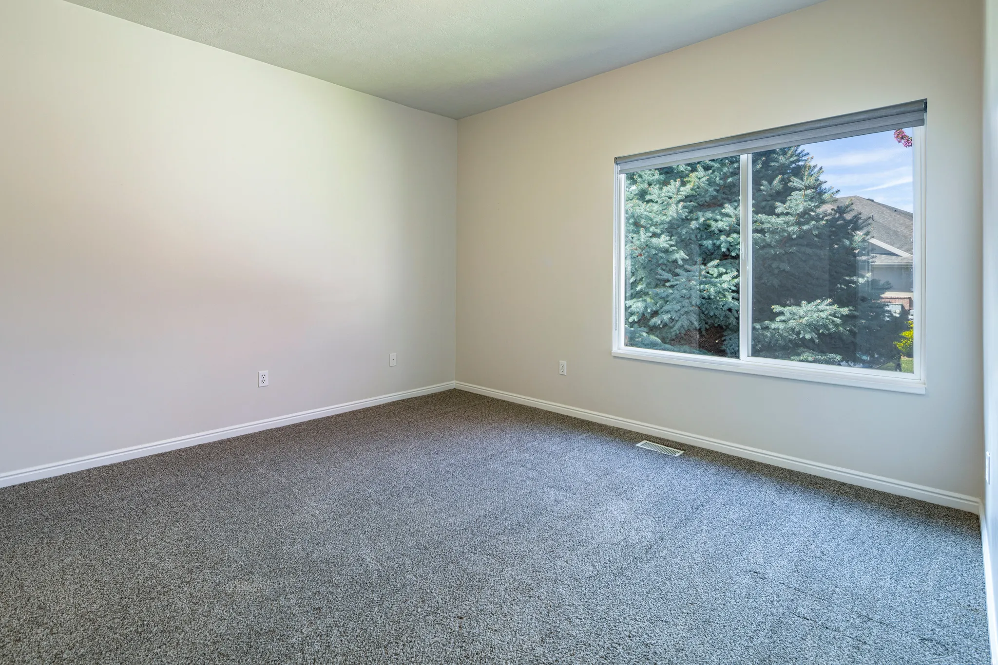 Unfurnished room featuring dark colored carpet and baseboards