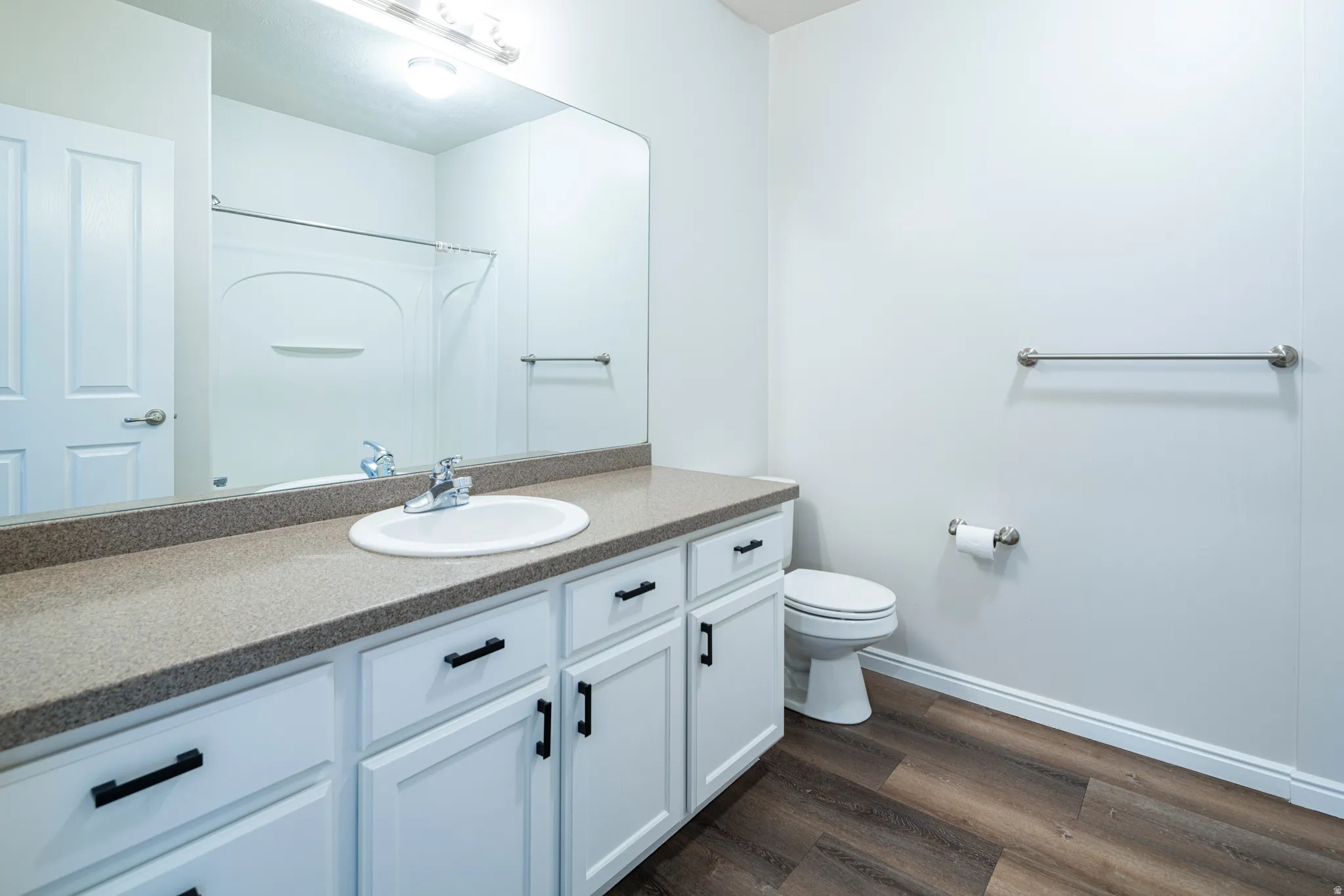 Bathroom featuring dark wood-type flooring and vanity