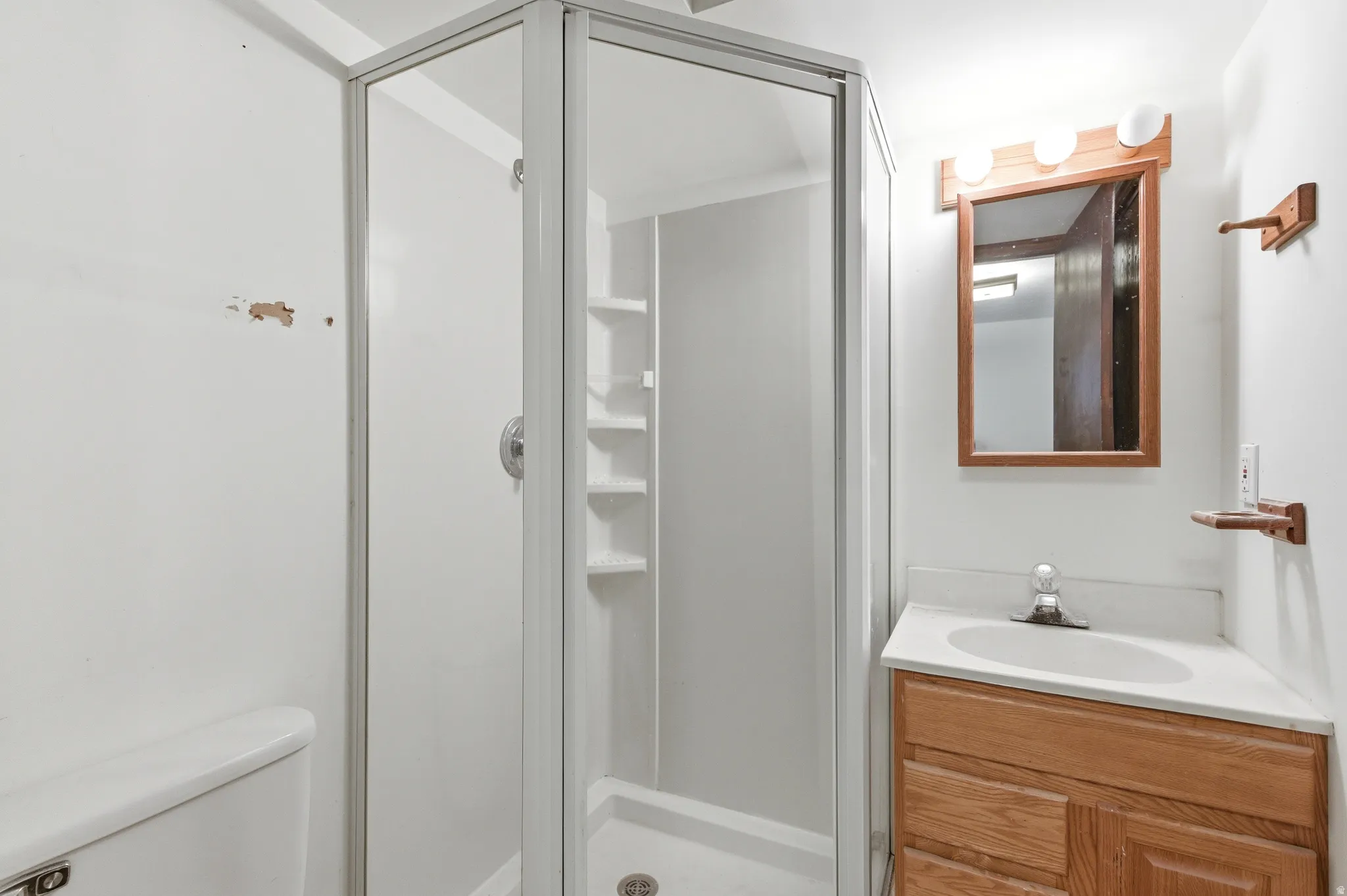 3/4 bath featuring a stall shower and vanity