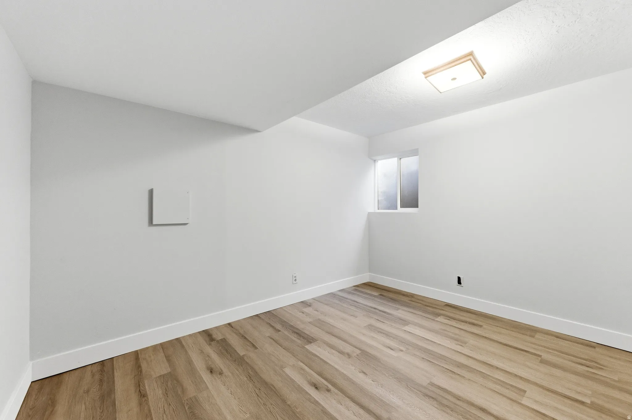 Bedroom featuring light wood finished floors and baseboards