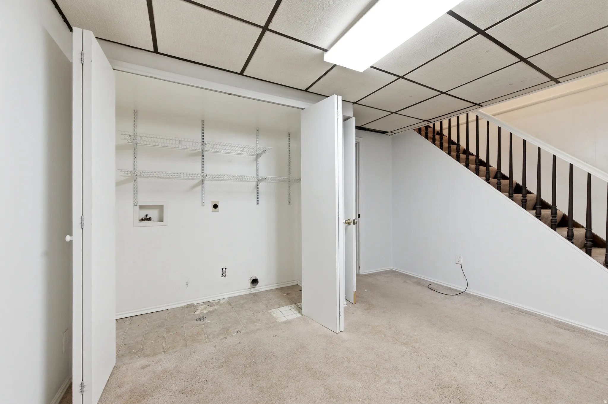 Laundry area featuring electric dryer hookup, carpet flooring, hookup for a washing machine, and a paneled ceiling