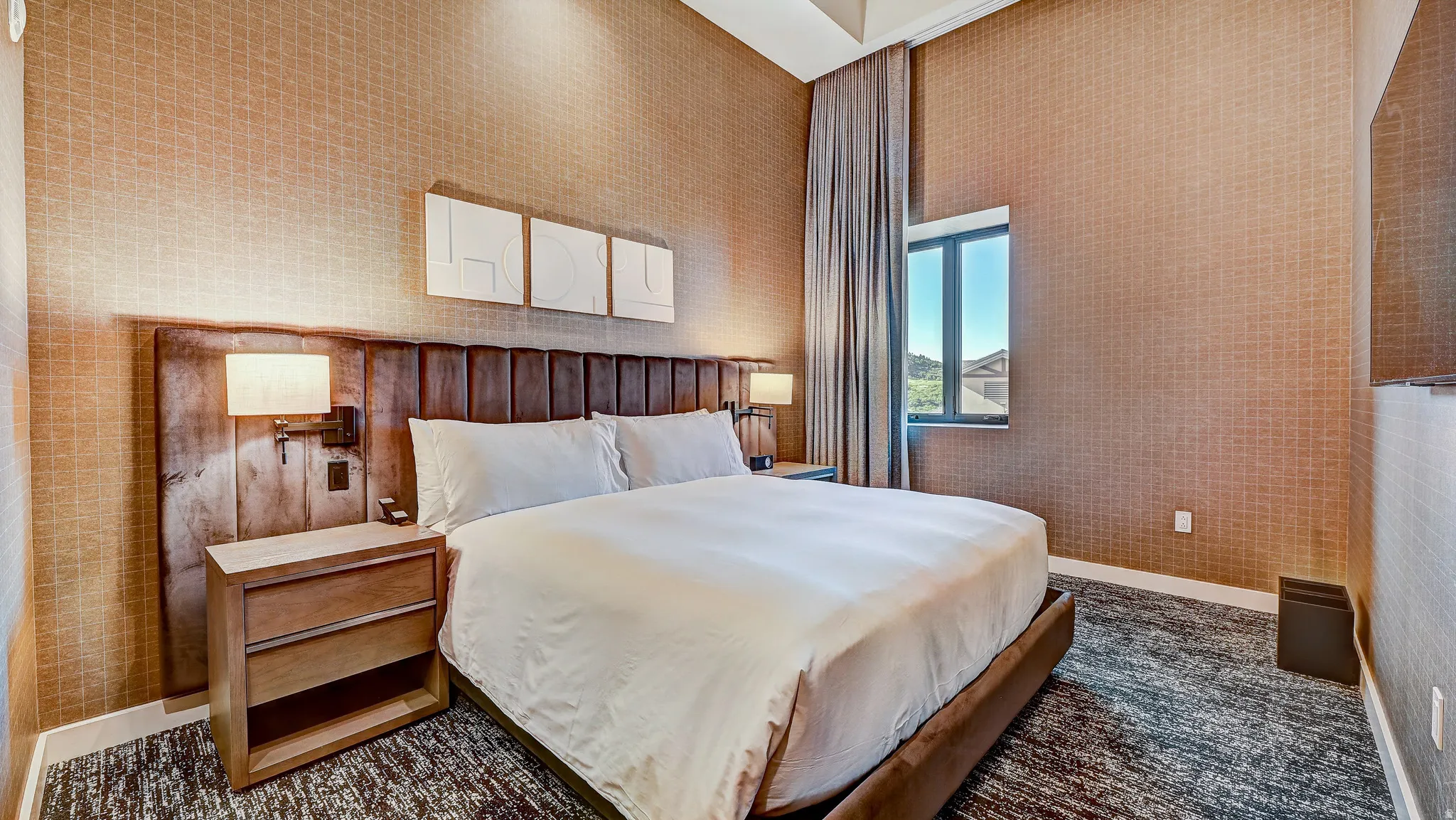 Bedroom featuring baseboards and wallpapered walls