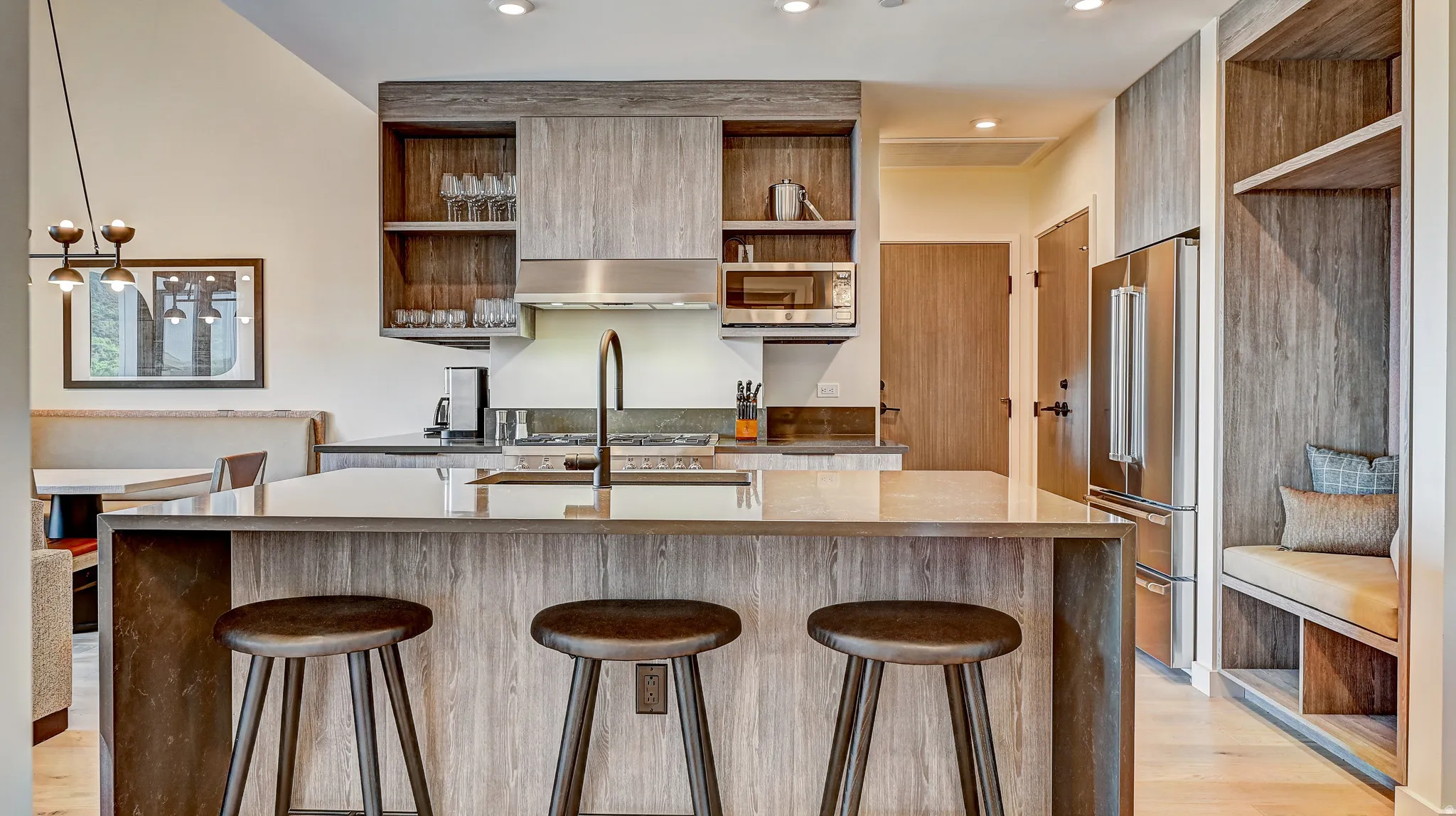 Kitchen featuring open shelves, dark stone countertops, stainless steel appliances, and recessed lighting