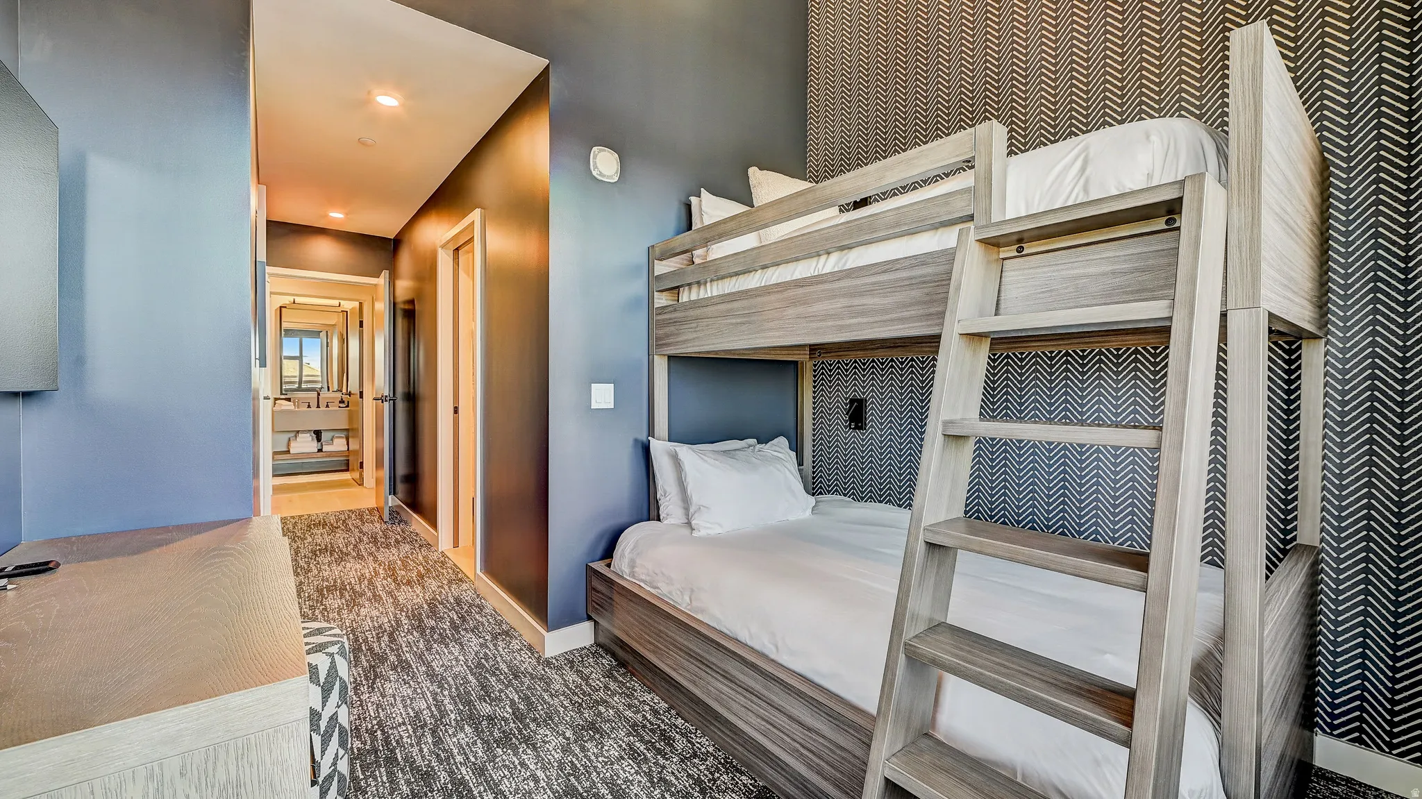 Bedroom with dark colored carpet and recessed lighting