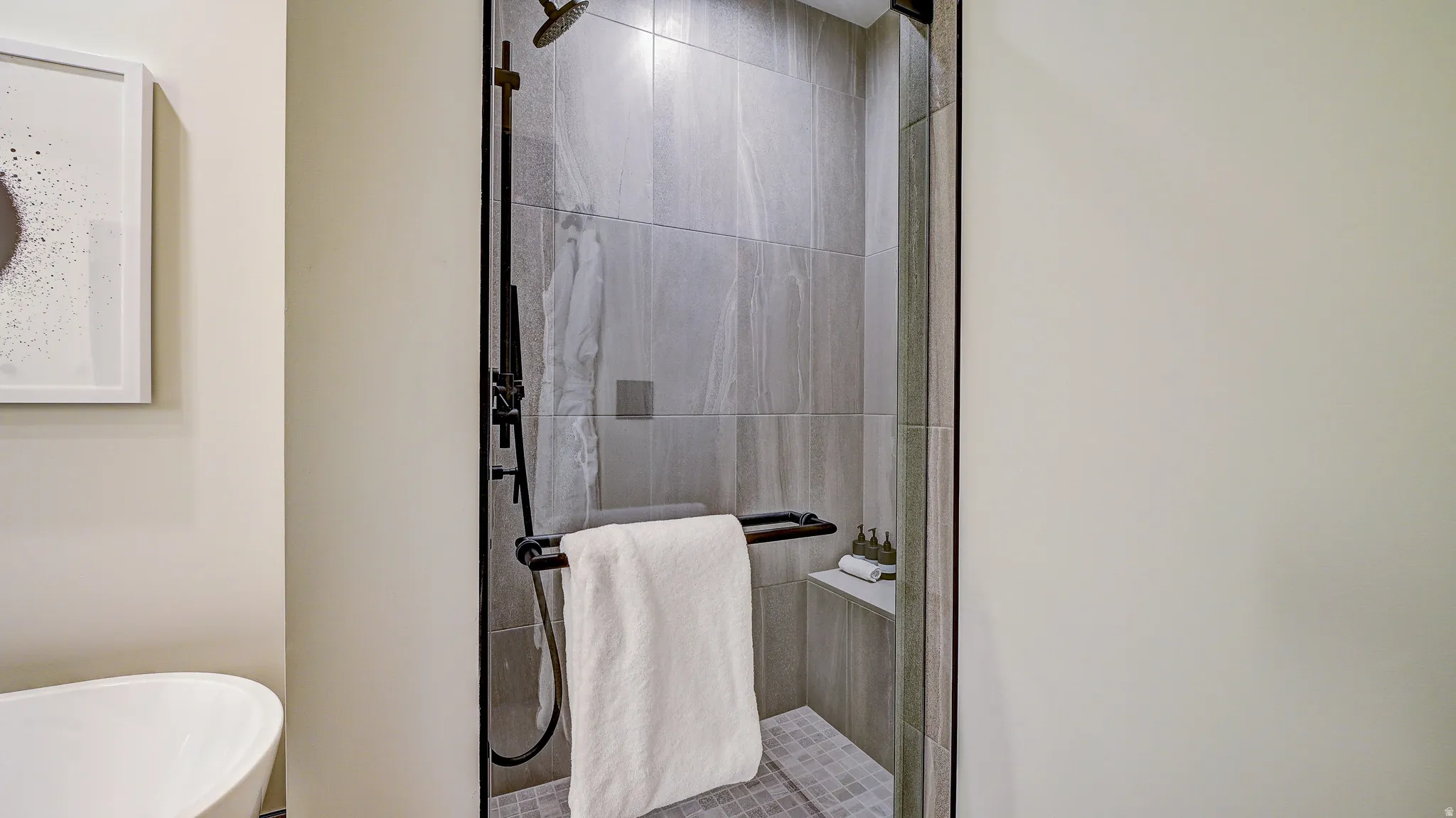 Full bath featuring a stall shower and a freestanding tub