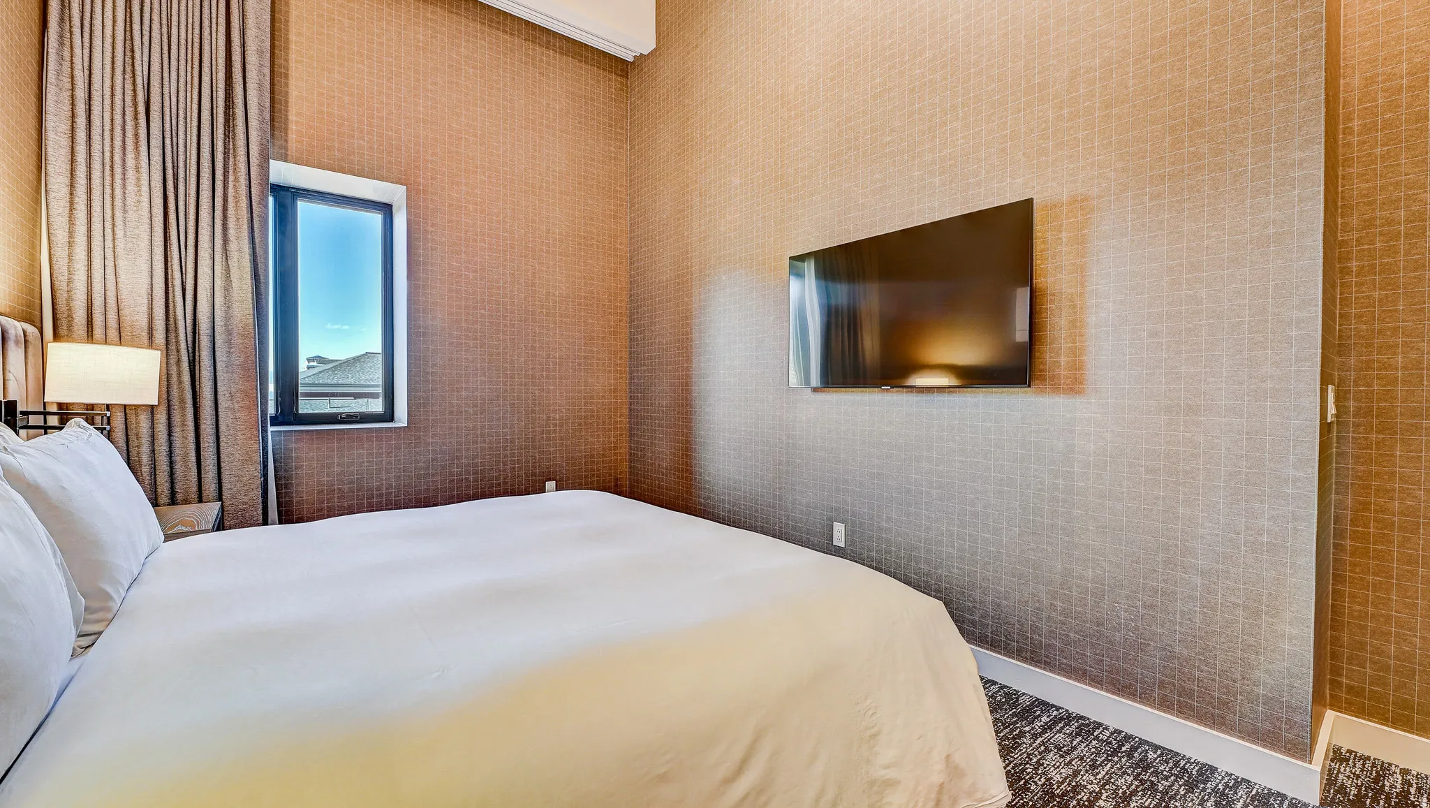 Bedroom with wallpapered walls