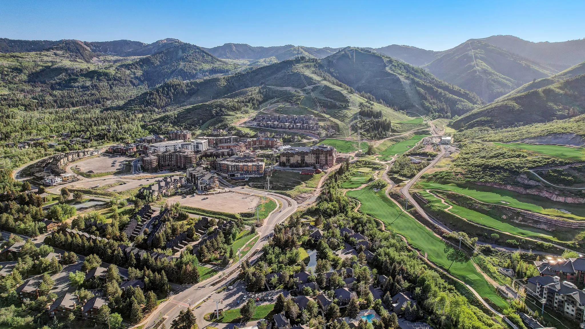 Bird's eye view of a mountainous background and a golf course