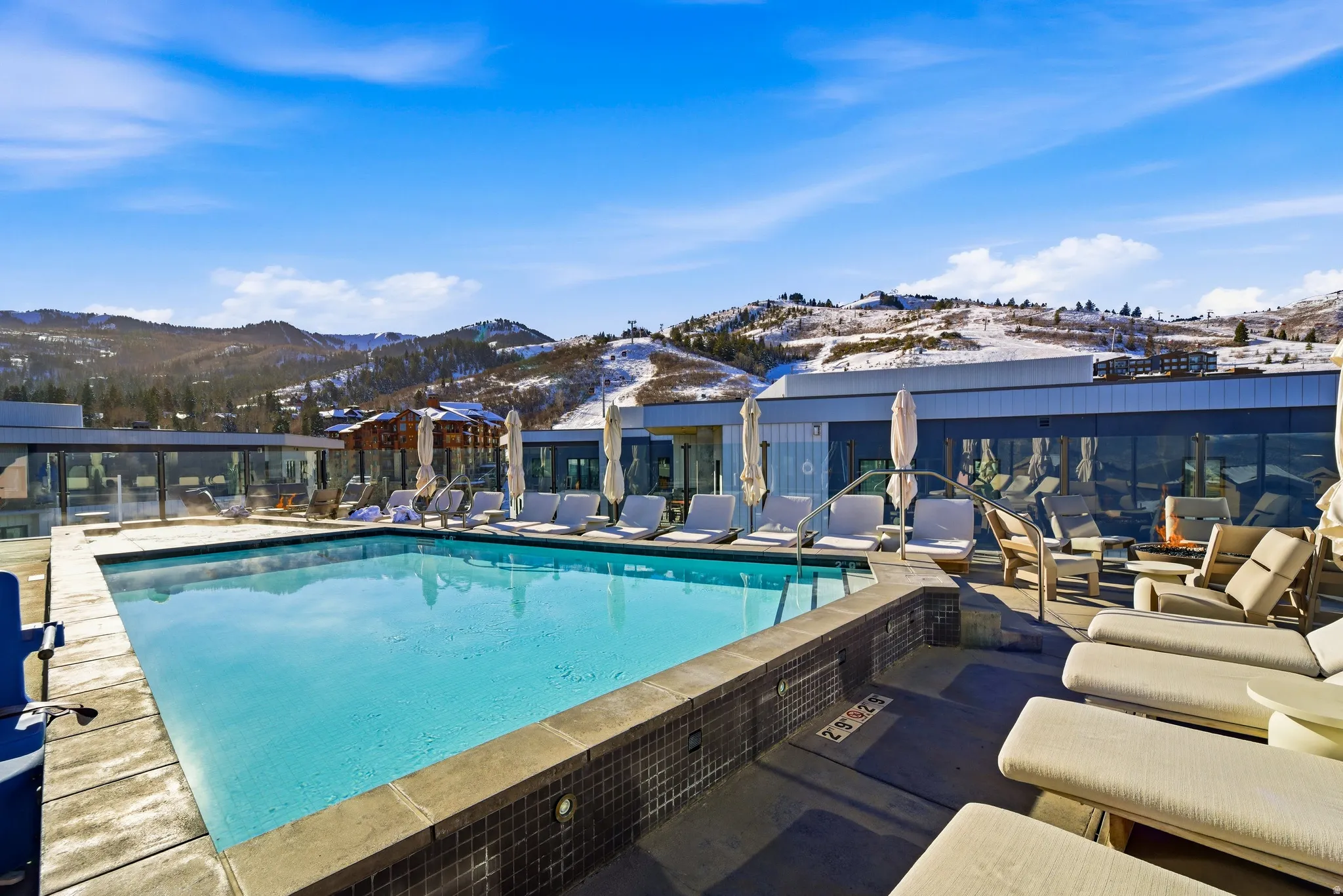 Community pool featuring a mountain view and a patio