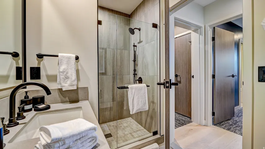 Bathroom with a shower stall and vanity