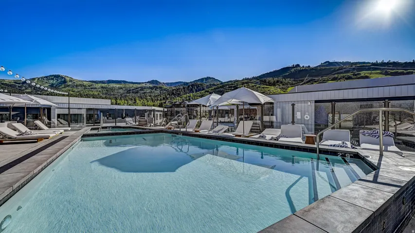 Community pool with a mountain view and a patio