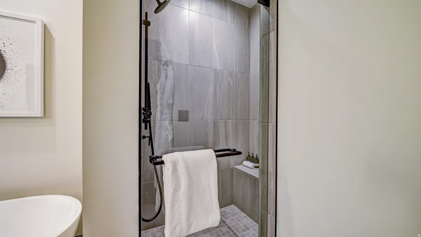 Full bath featuring a stall shower and a freestanding tub