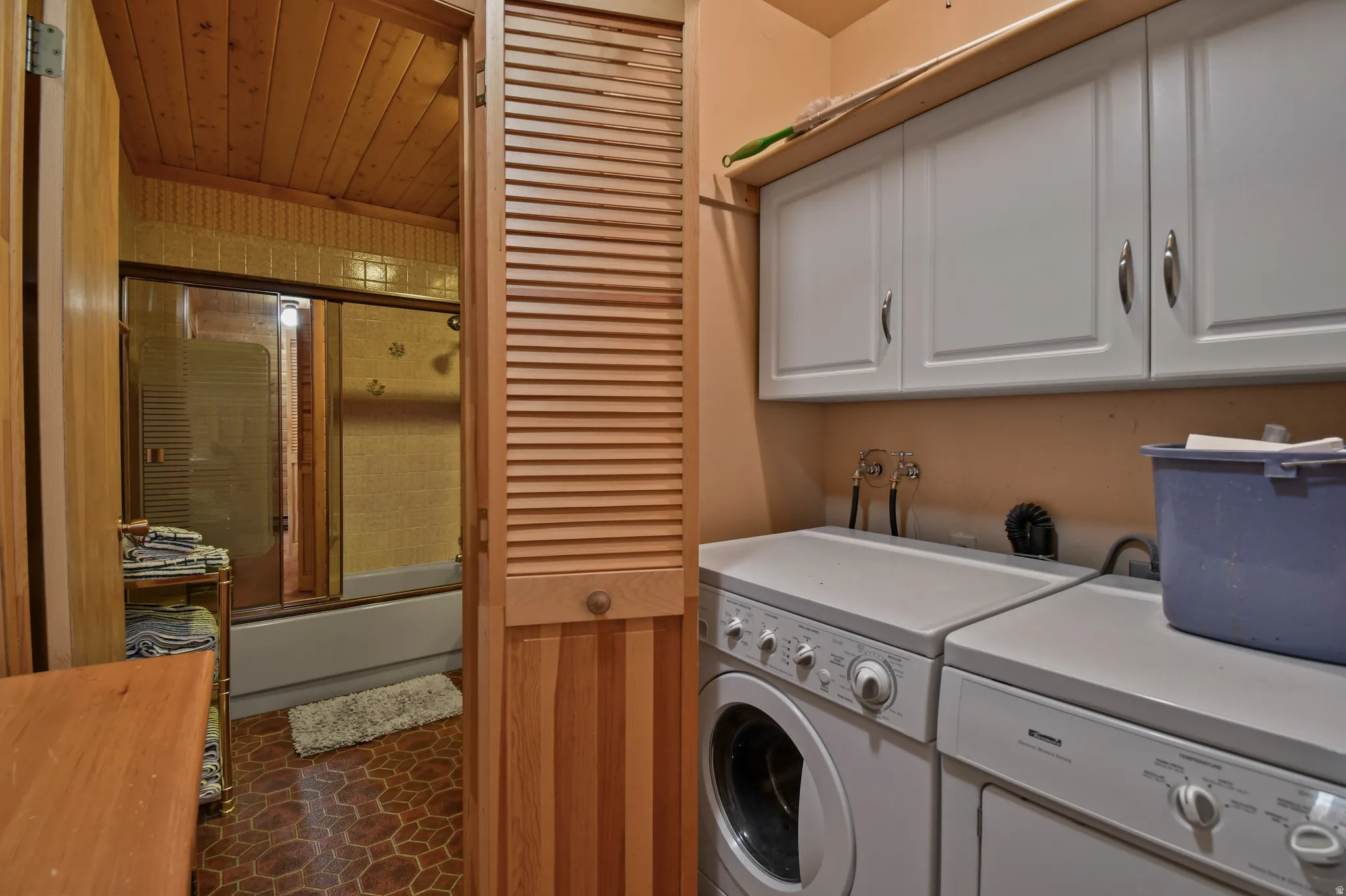 Laundry area with separate washer and dryer and cabinet space