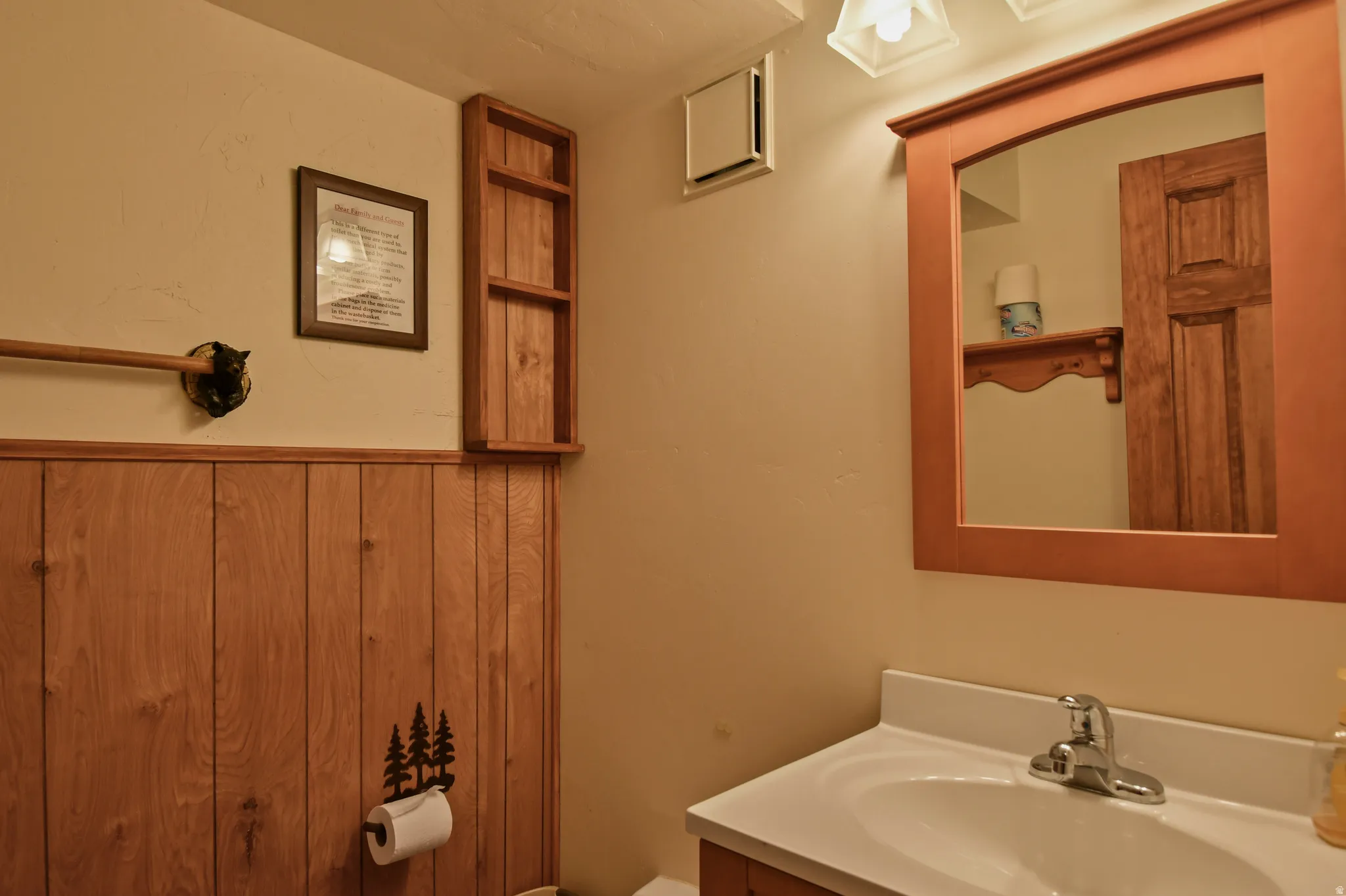 Half bathroom with vanity and toilet