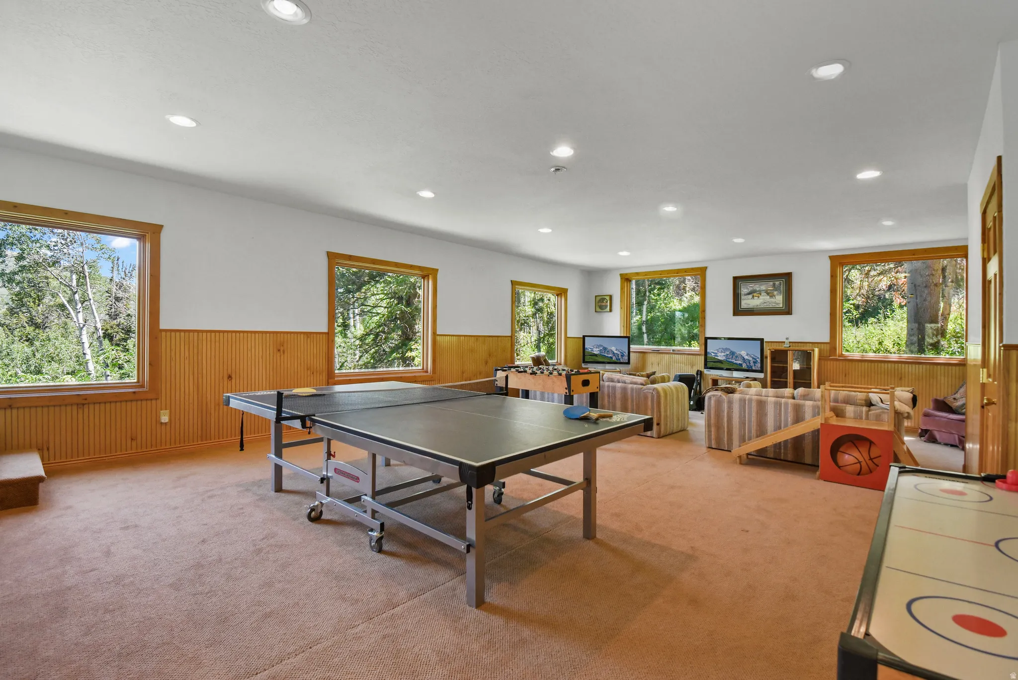 Playroom with wainscoting, wooden walls, light carpet, and recessed lighting