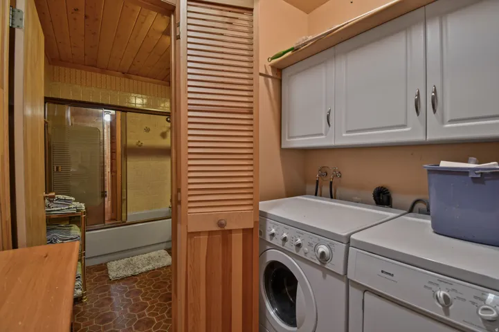 Laundry area with separate washer and dryer and cabinet space