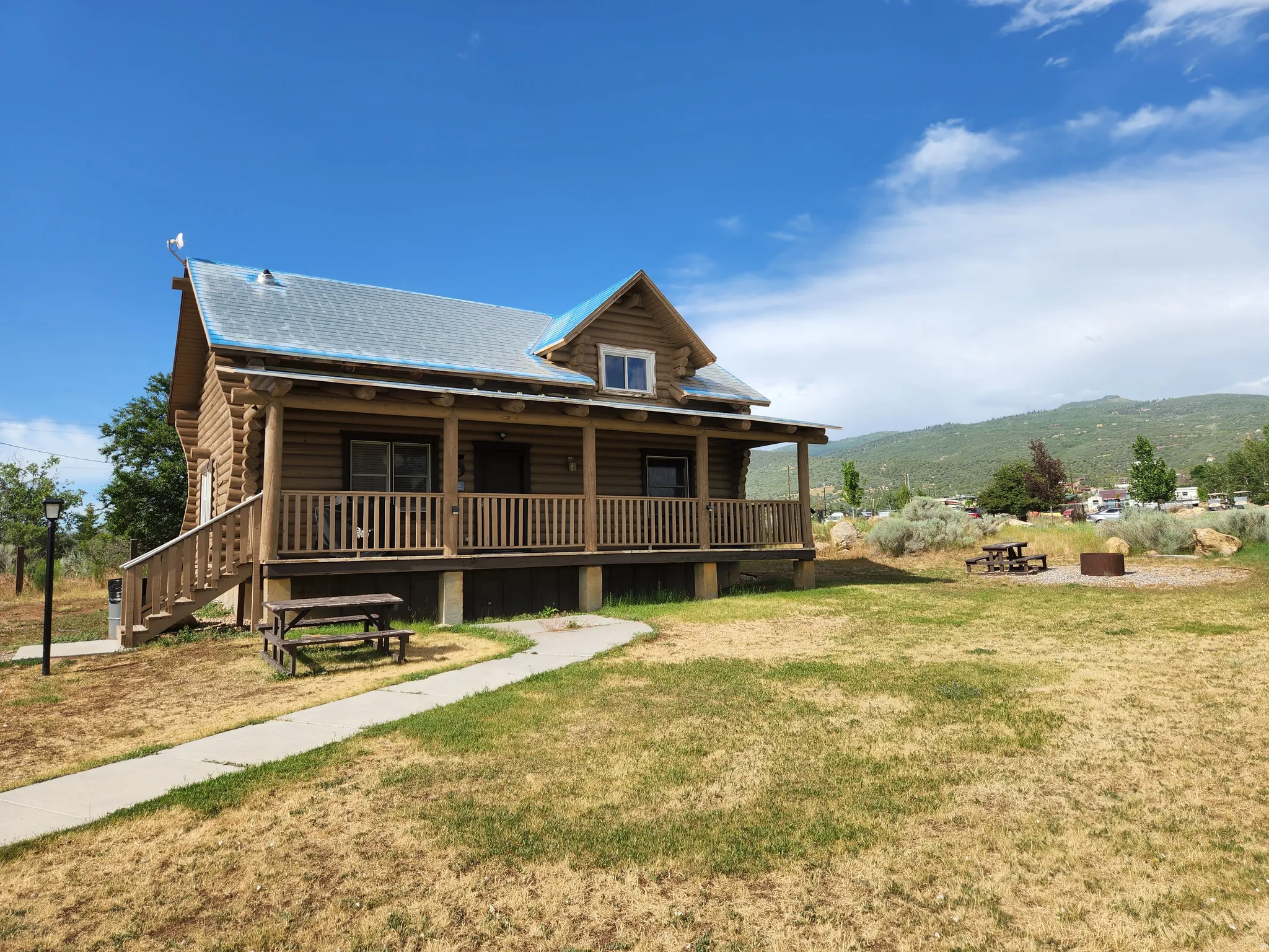 View of front facade featuring a porch and a front yard