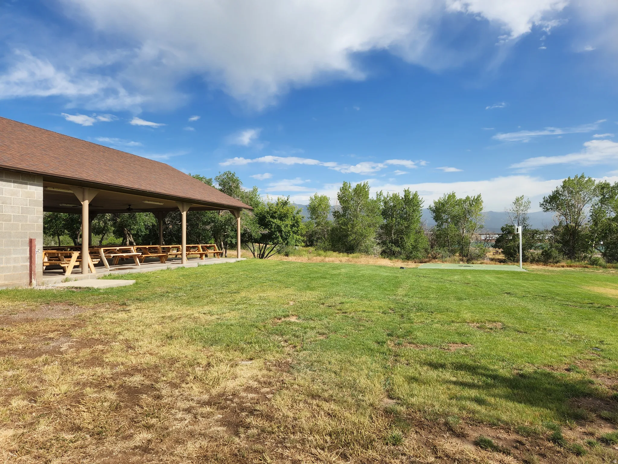 View of green lawn featuring a patio area