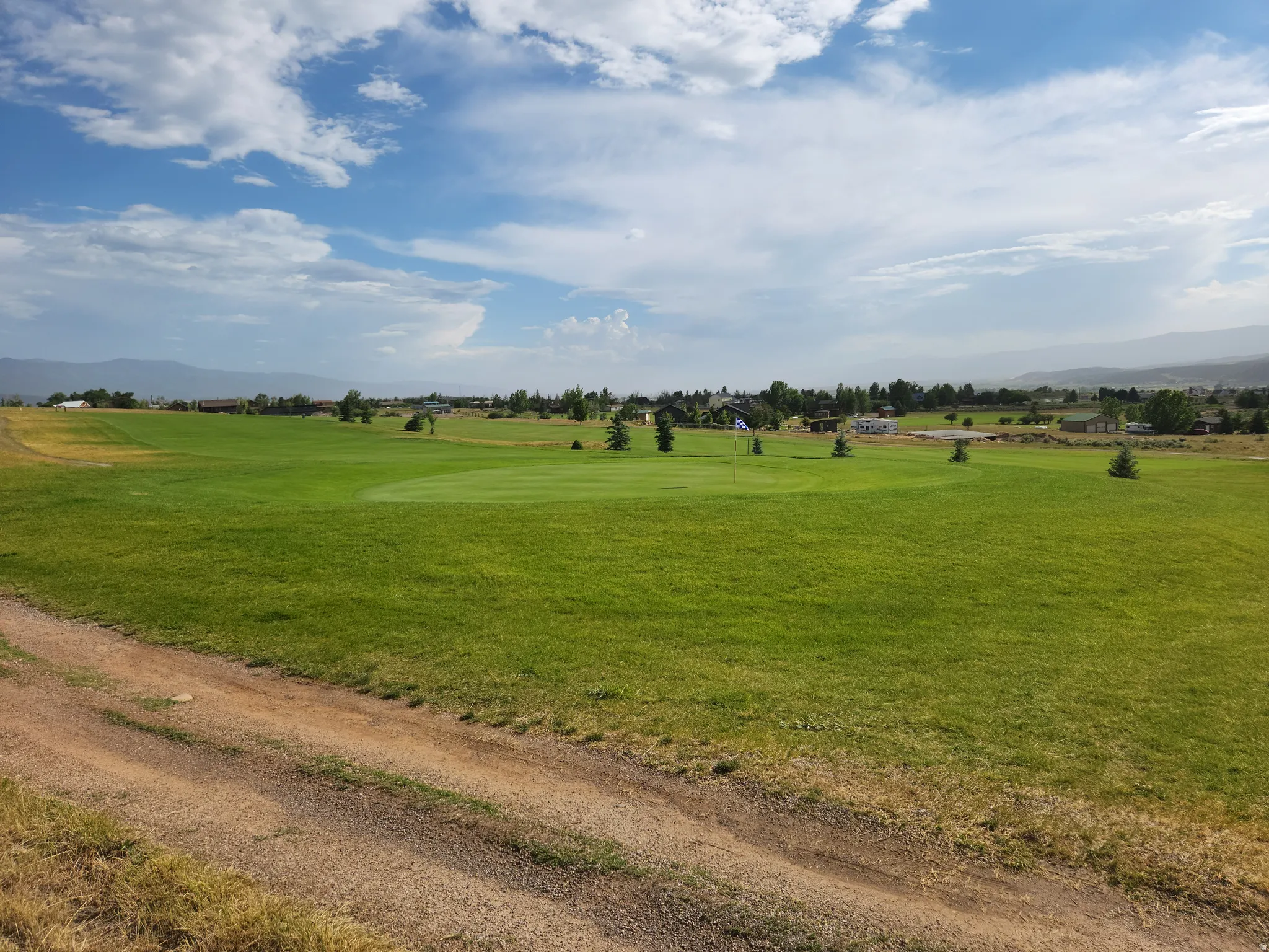View of home's community with a mountain view and view of golf course
