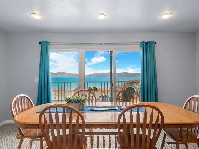 Dining room featuring a textured ceiling, a water and mountain view, and recessed lighting