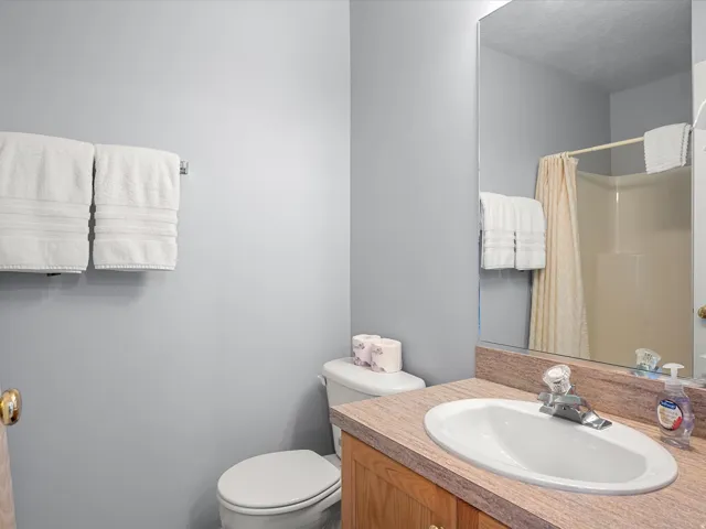 Full bath with vanity and curtained shower