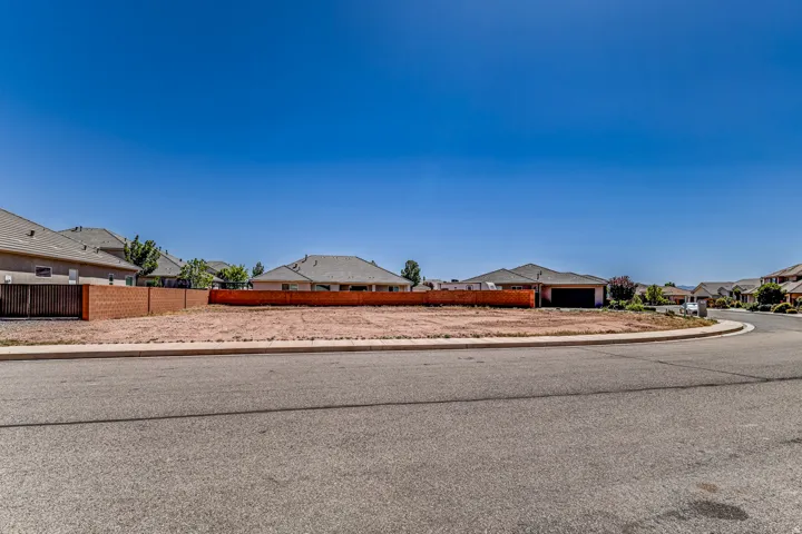 View of asphalt road with sidewalks, a residential view, and curbs