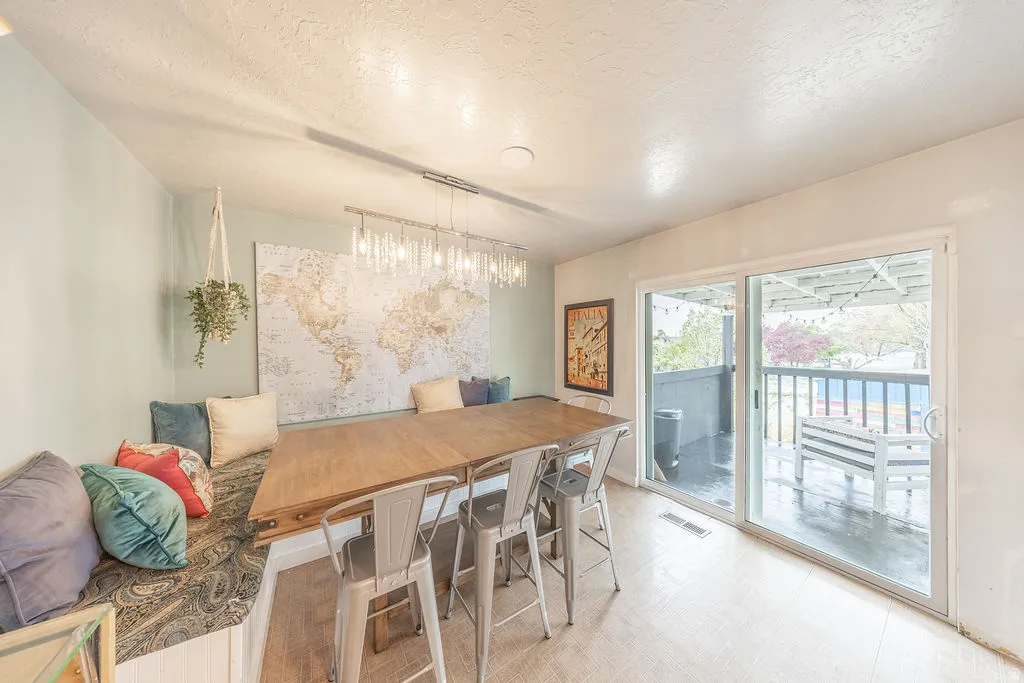 Dining space with a textured ceiling and light flooring