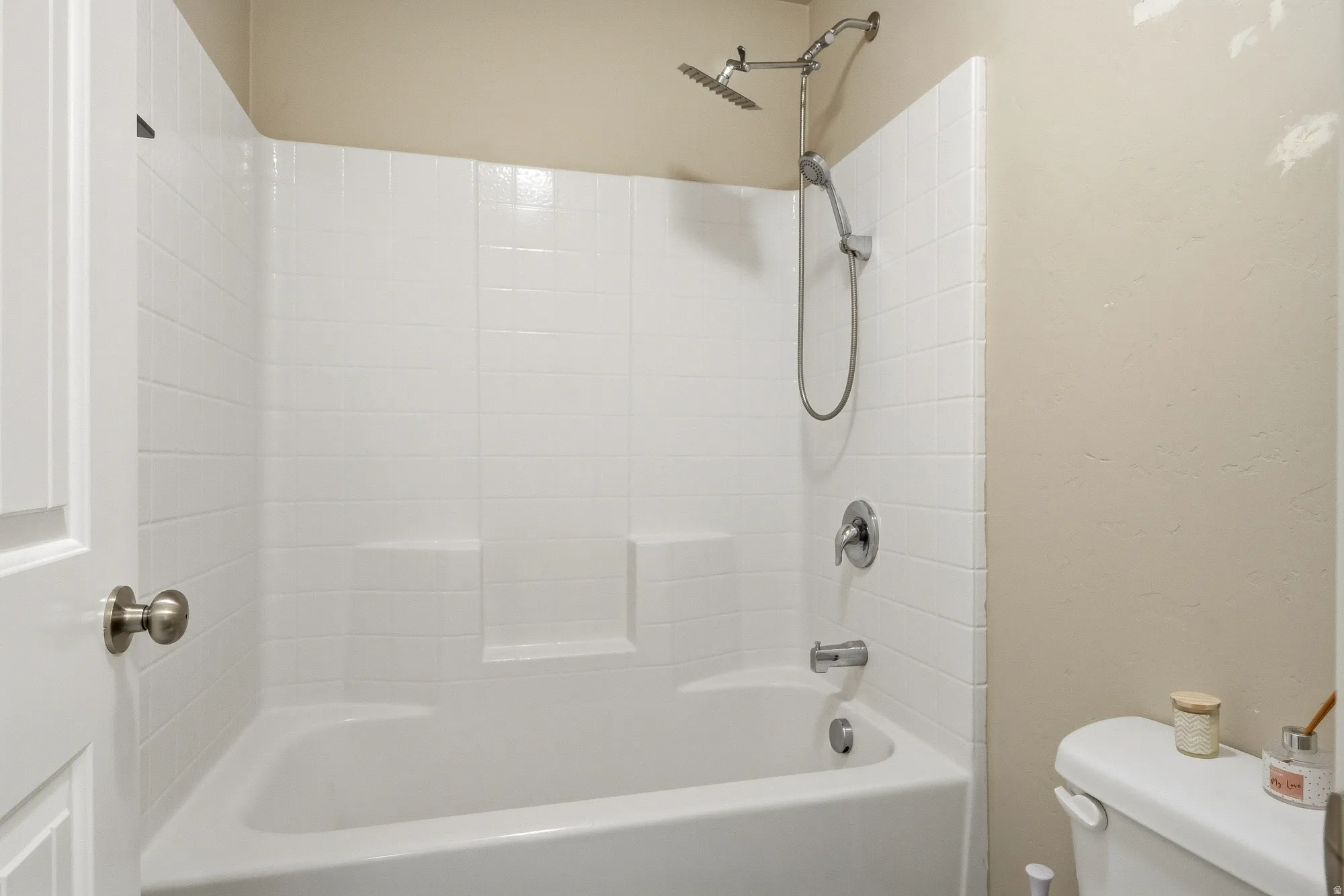 Bathroom featuring toilet and  shower combination
