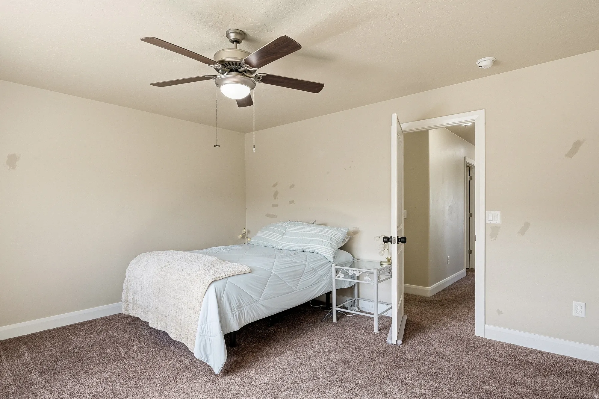 Bedroom with carpet and a ceiling fan