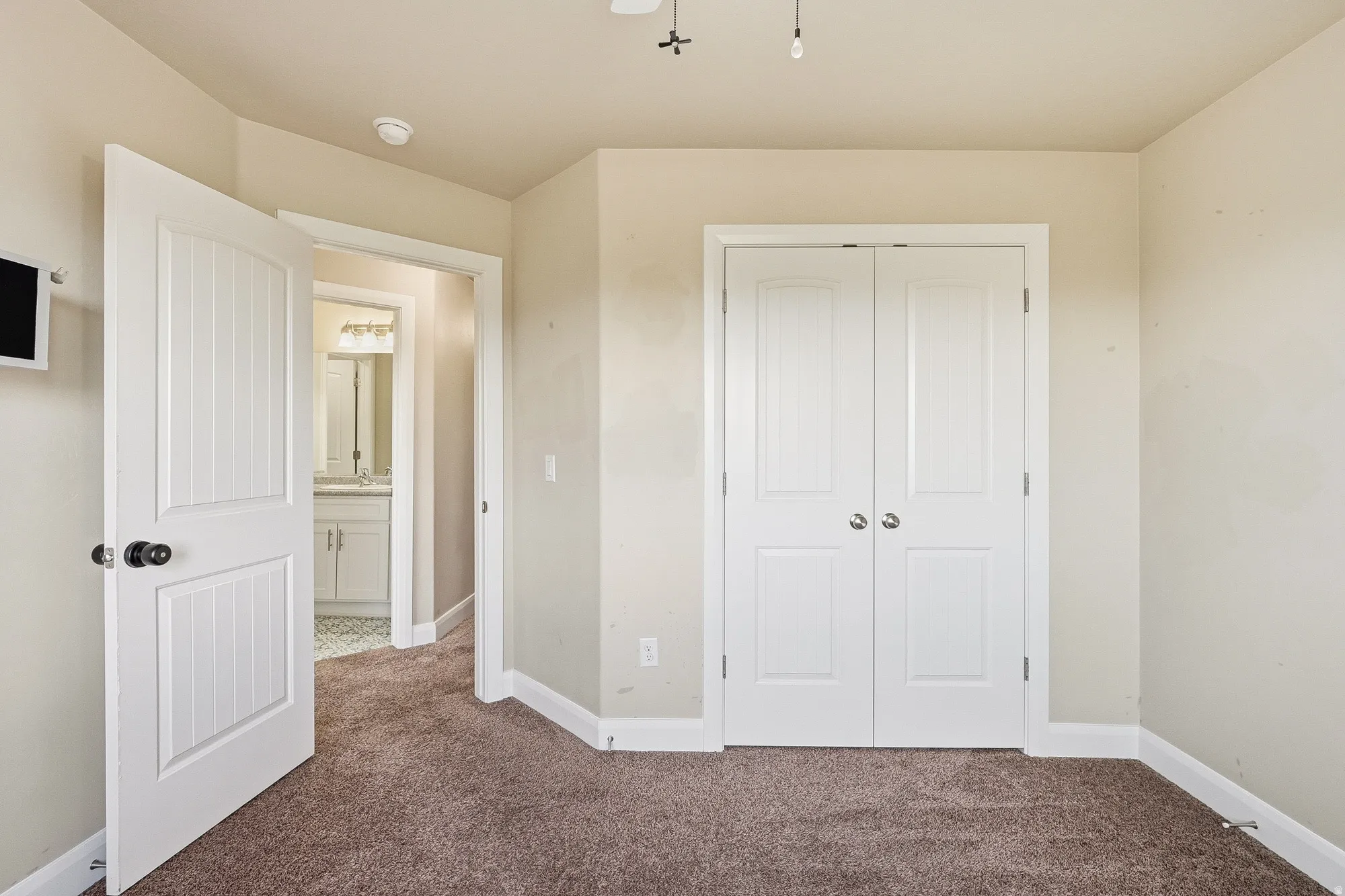 Unfurnished bedroom featuring dark carpet and a closet