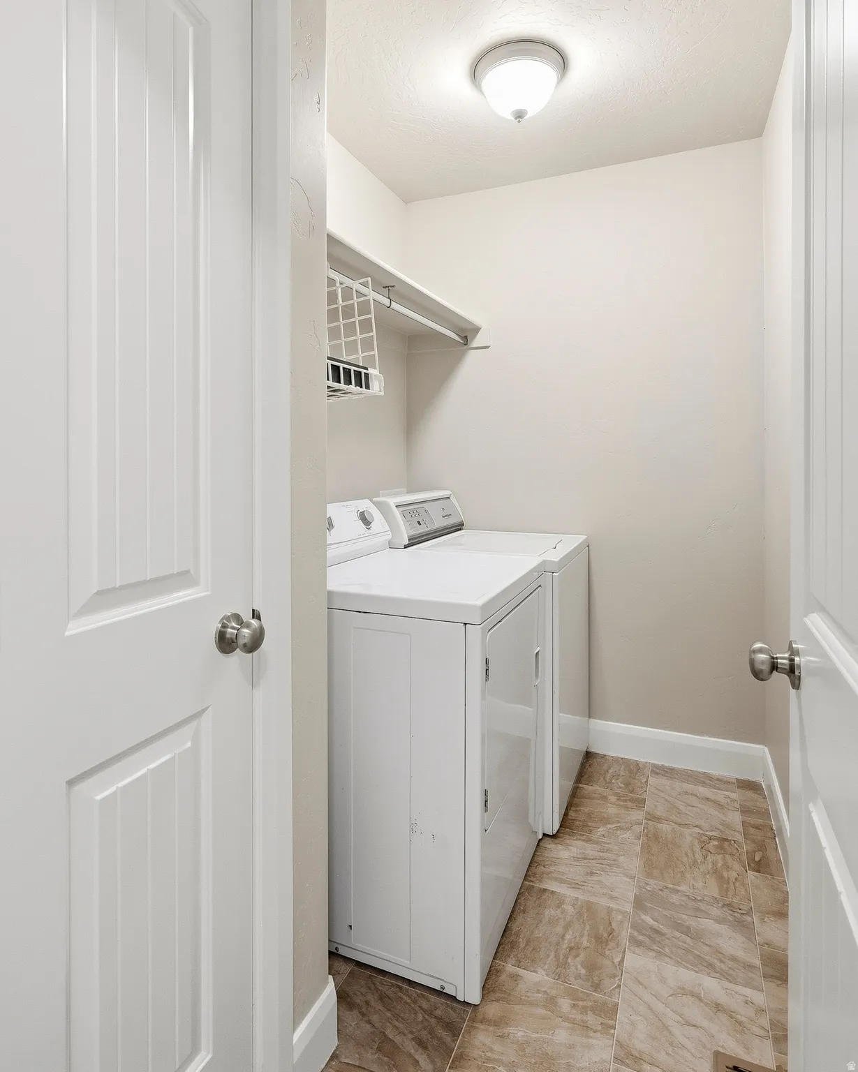 Dedicated laundry area with durable tile flooring