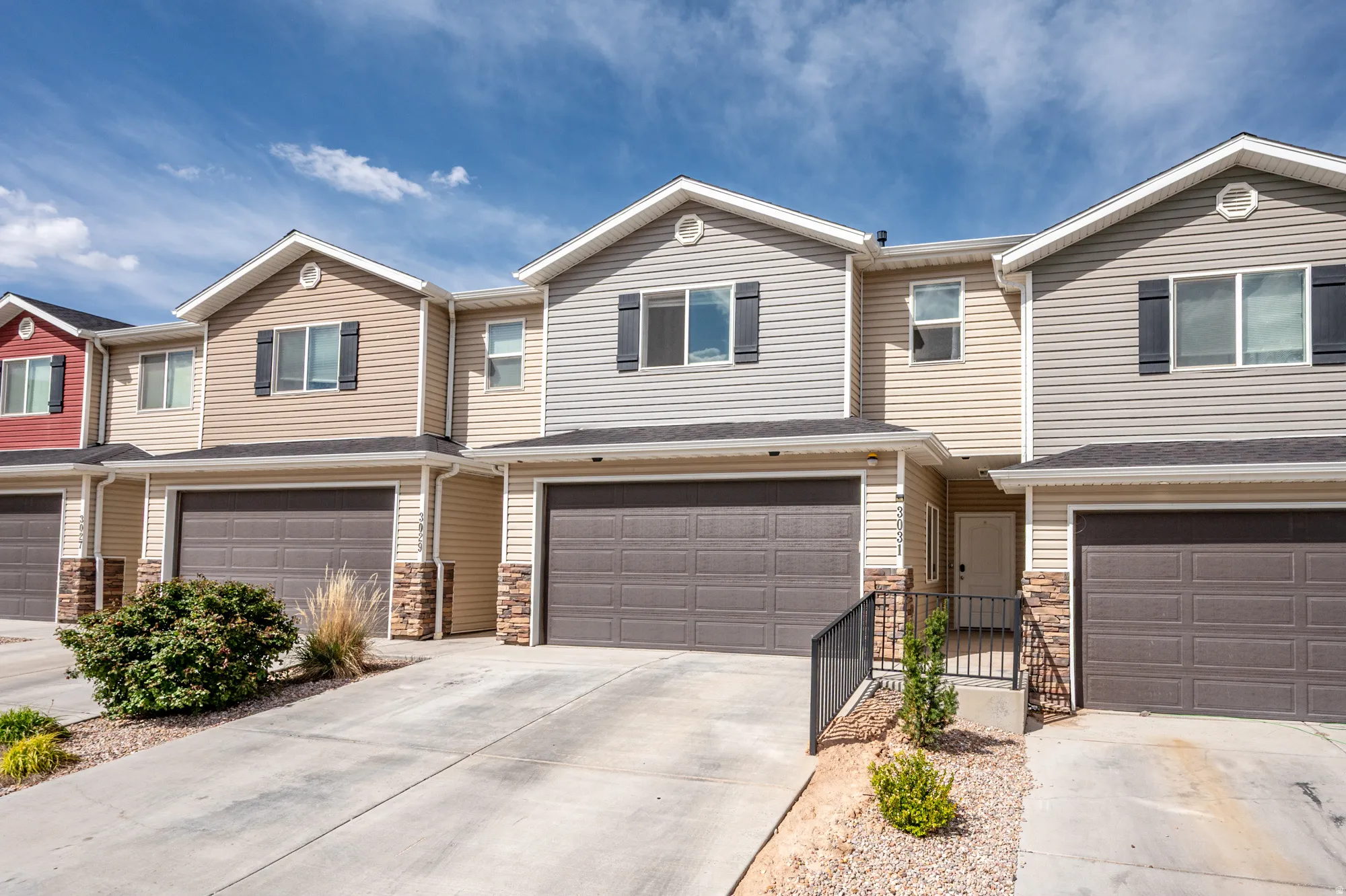 Townhome exterior featuring horizontal siding and dark shutters