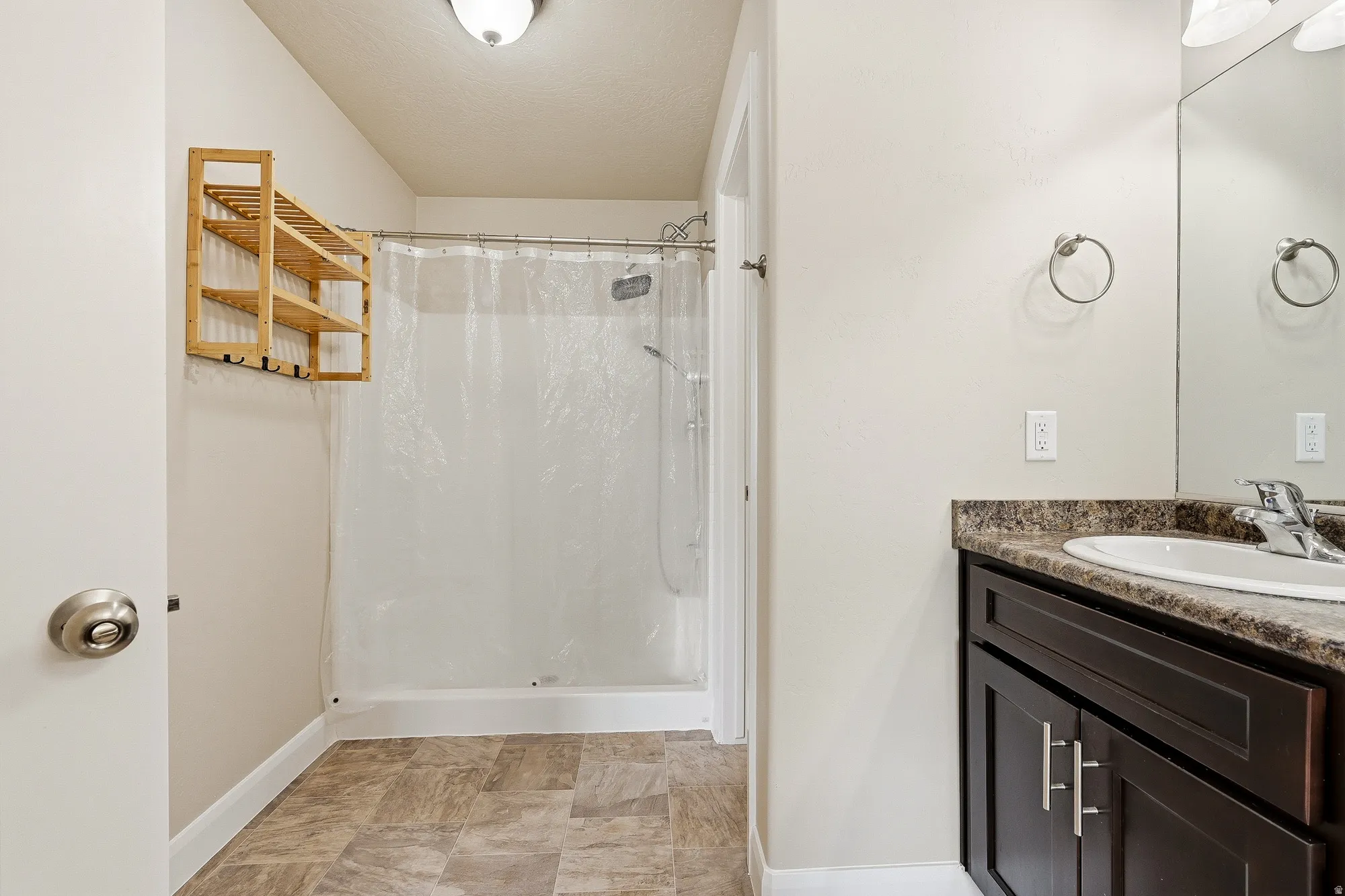 Full bathroom featuring vanity and a stall shower