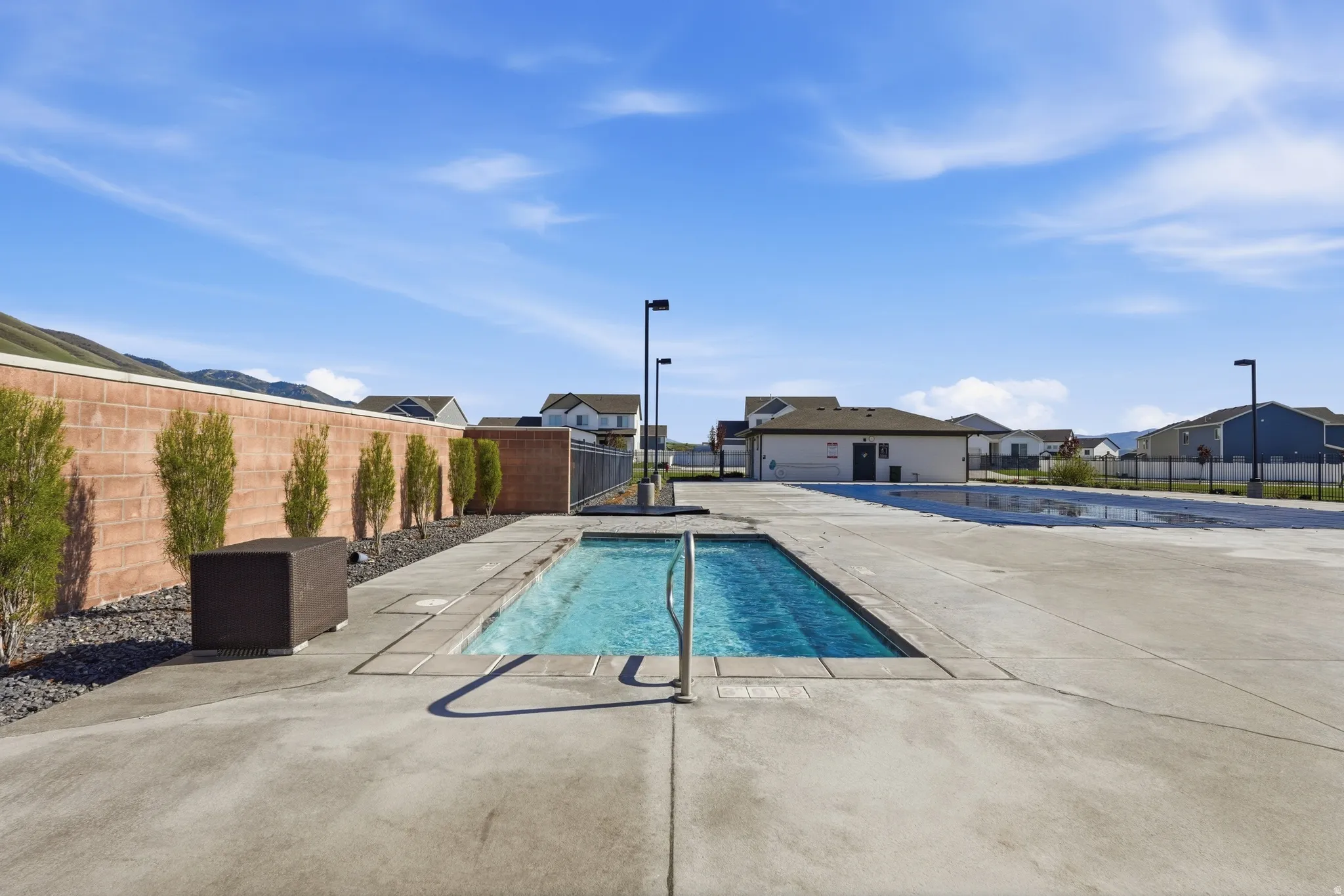 Community pool with a residential view and a patio area