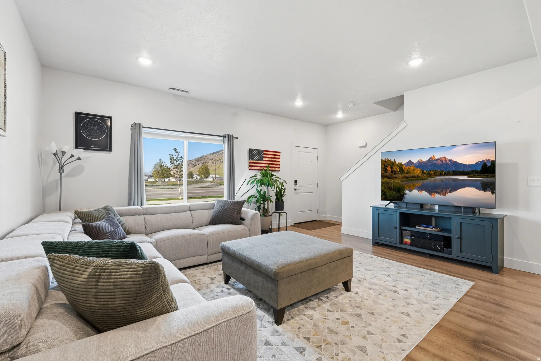 Living area featuring wood finished floors and recessed lighting