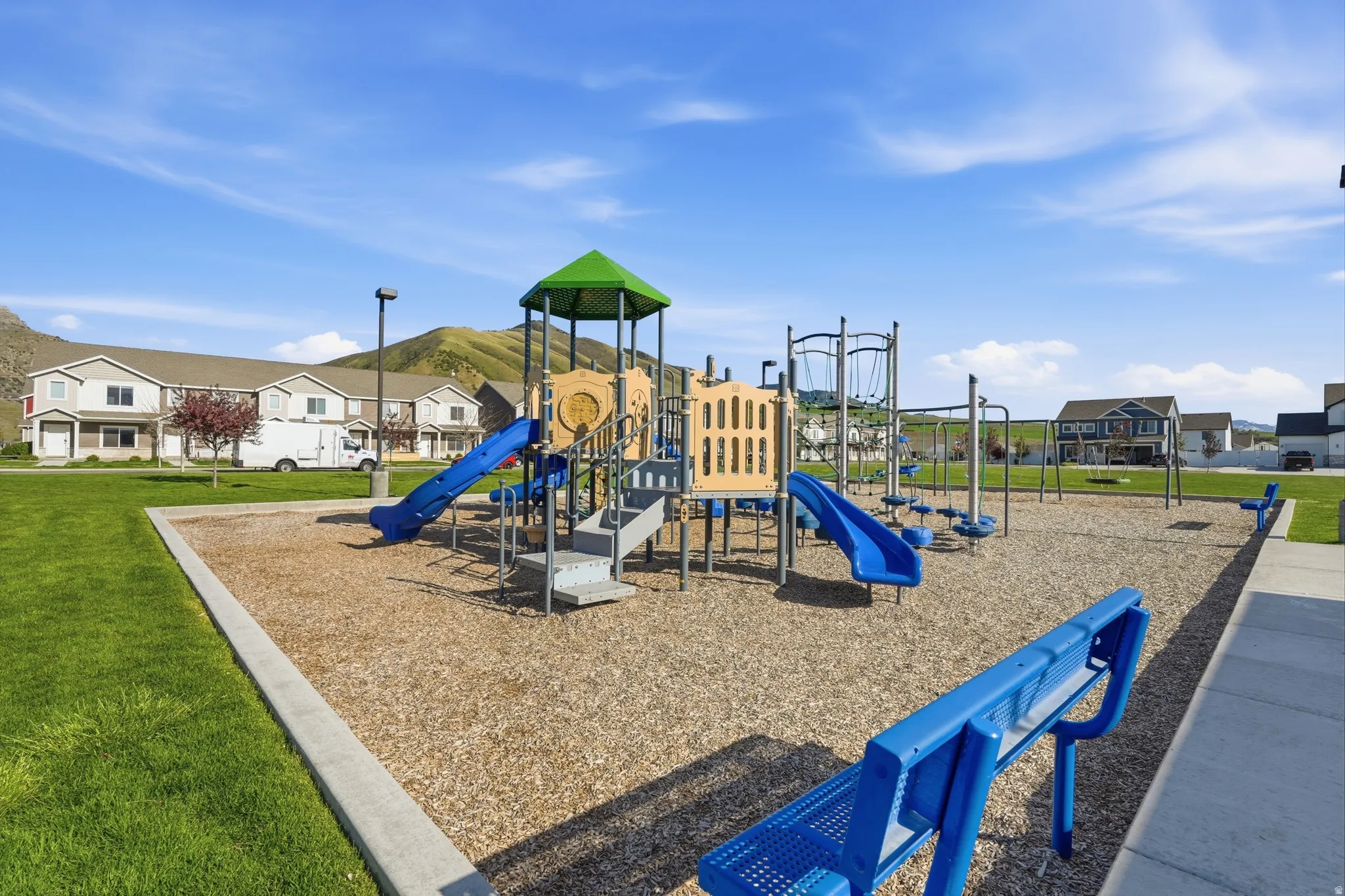 Community jungle gym featuring a yard and a residential view