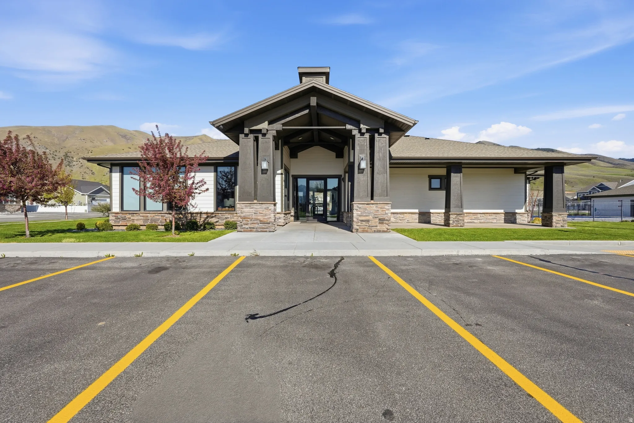 View of building exterior featuring a mountain view and uncovered parking
