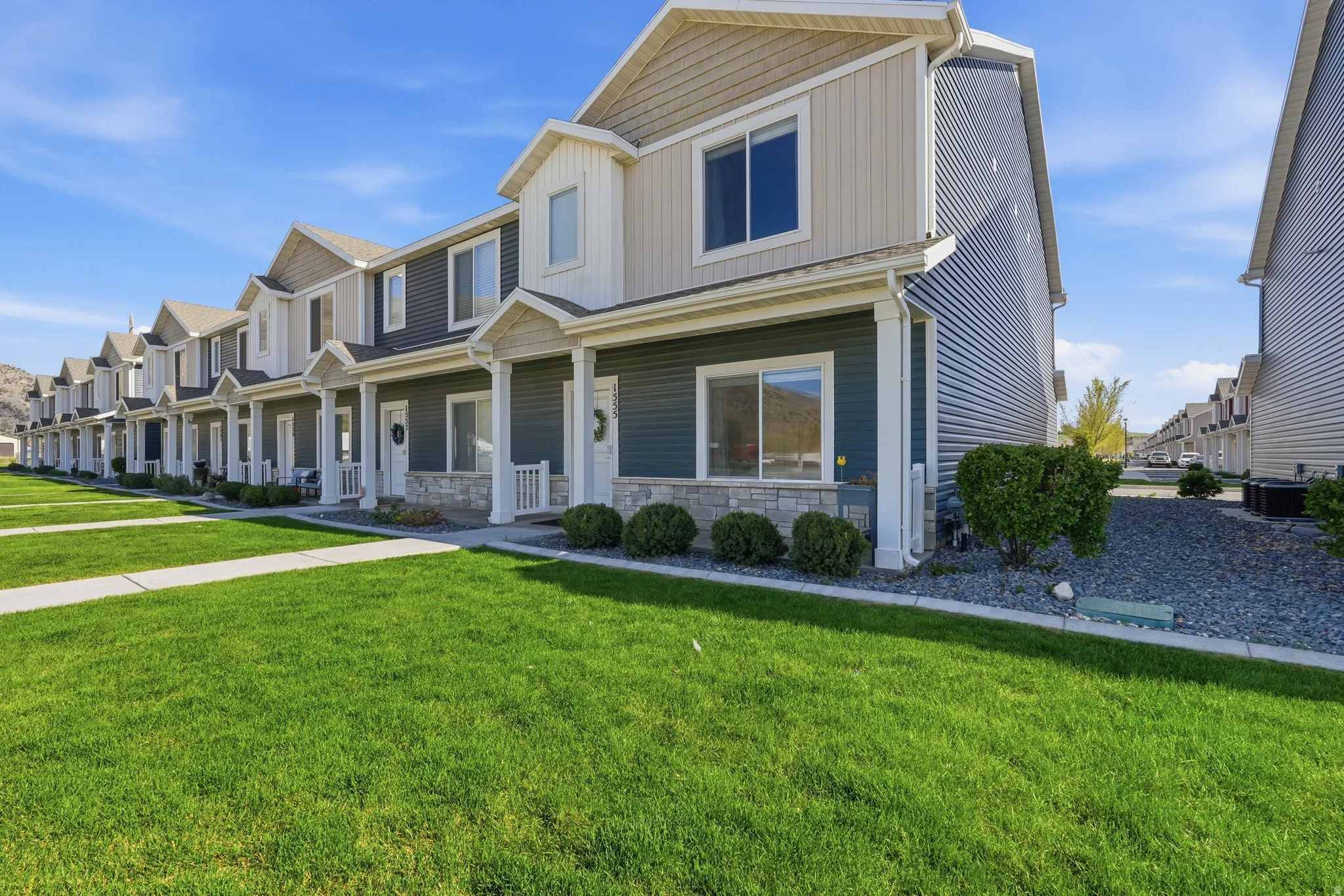 View of front of house with a porch, a front lawn, and a residential view