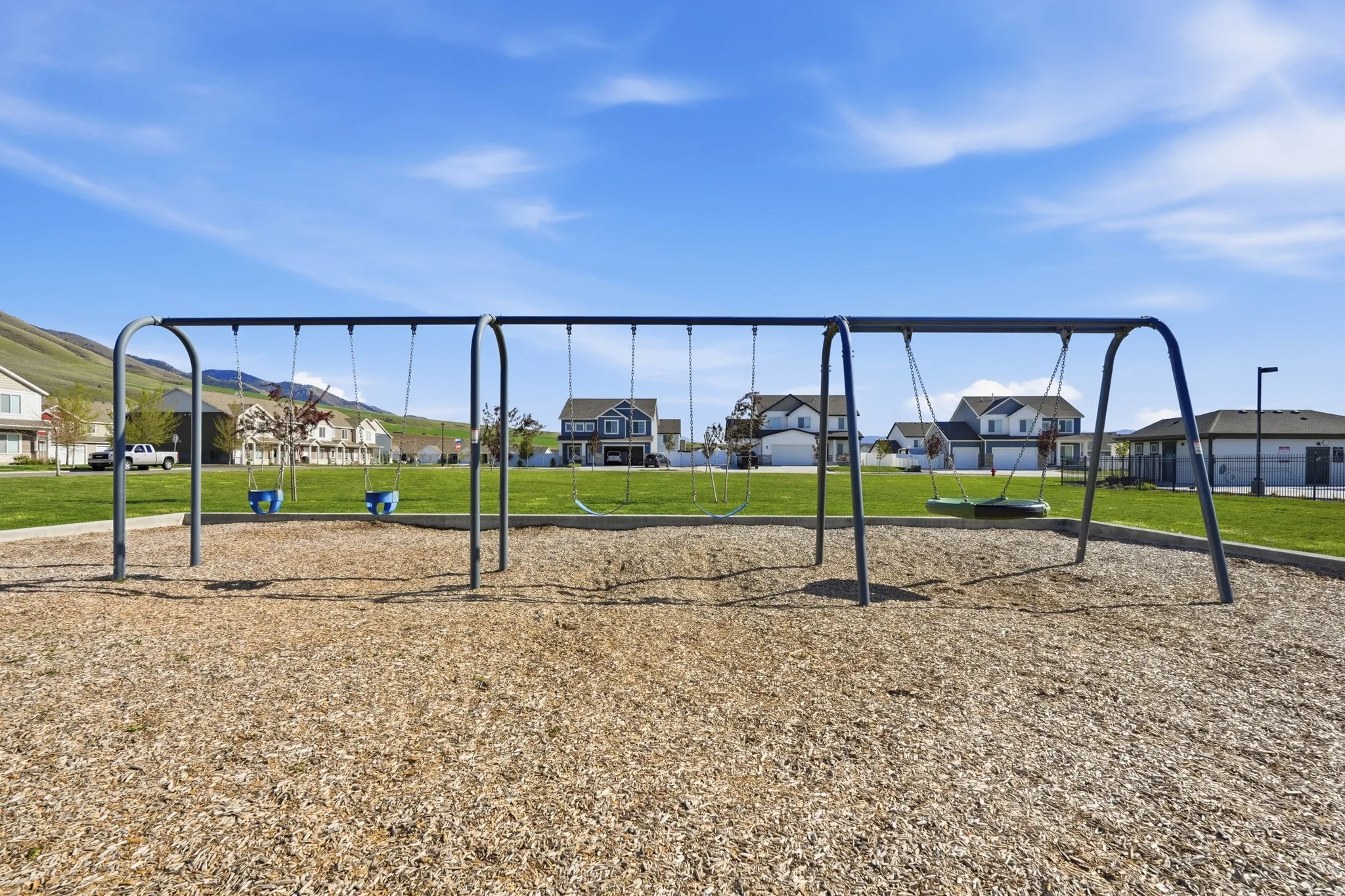 Community play area featuring a residential view and a lawn
