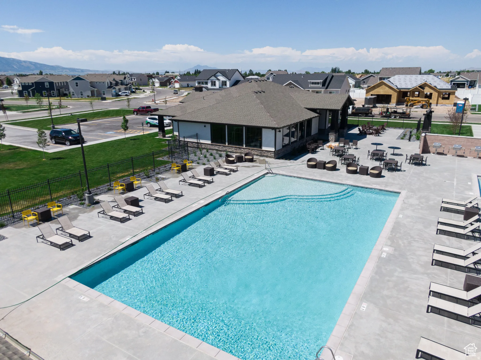 Community pool with a patio and a residential view