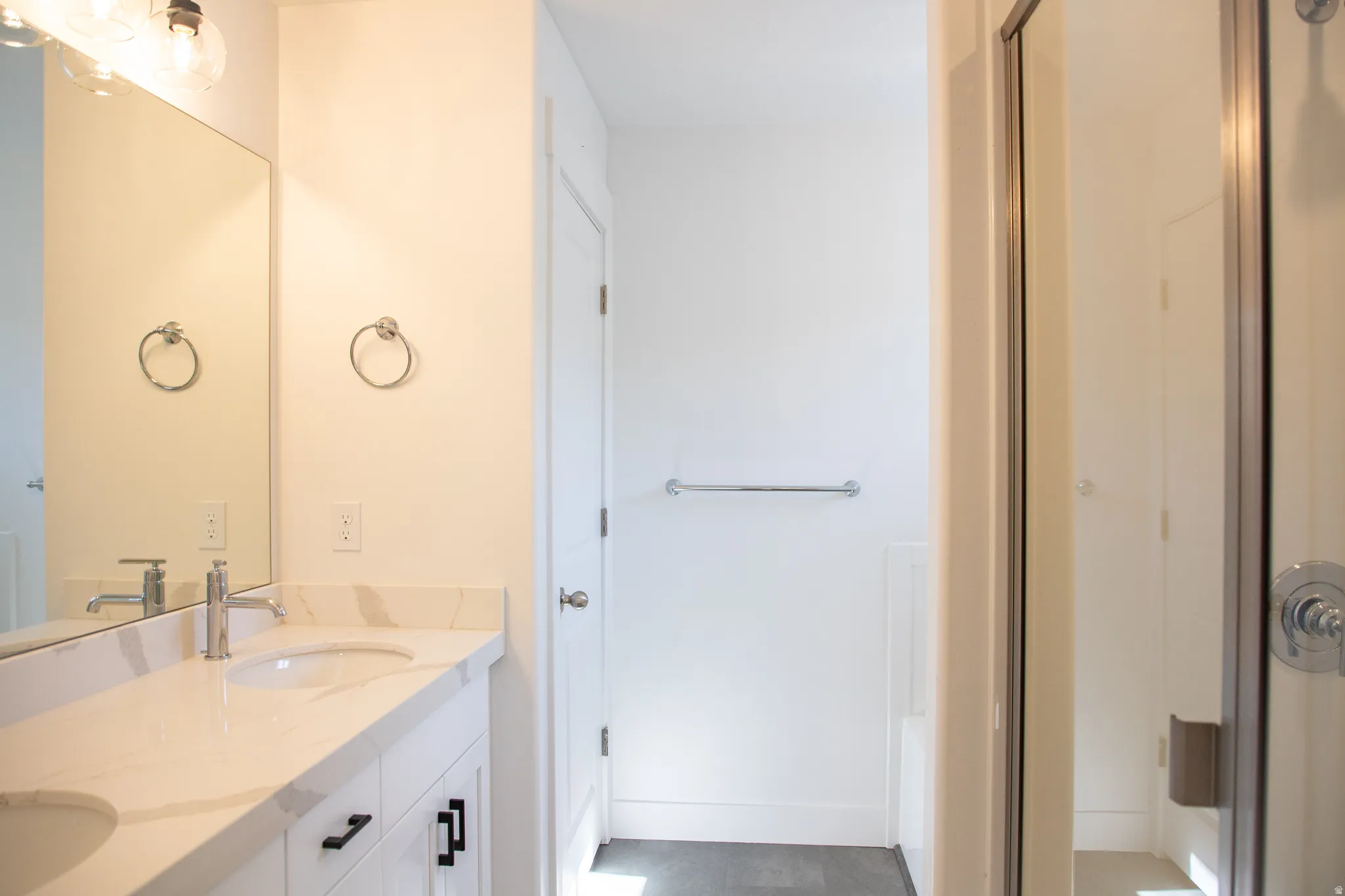 Primary bathroom with double vanity and a separate tub and shower