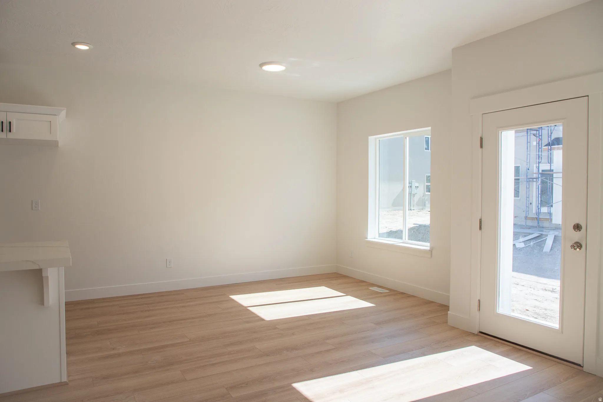 Dining area with recessed lighting and a large window