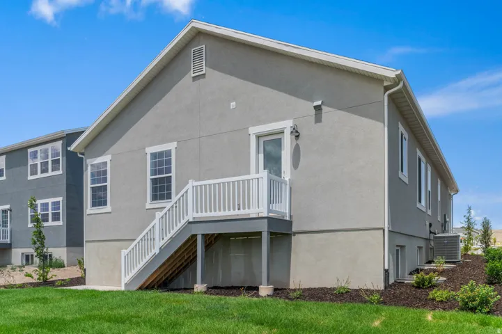 Rear exterior with stucco siding and multiple windows