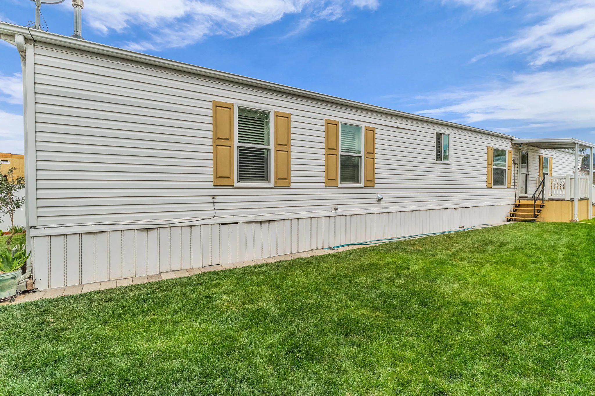 View of side of home featuring a yard