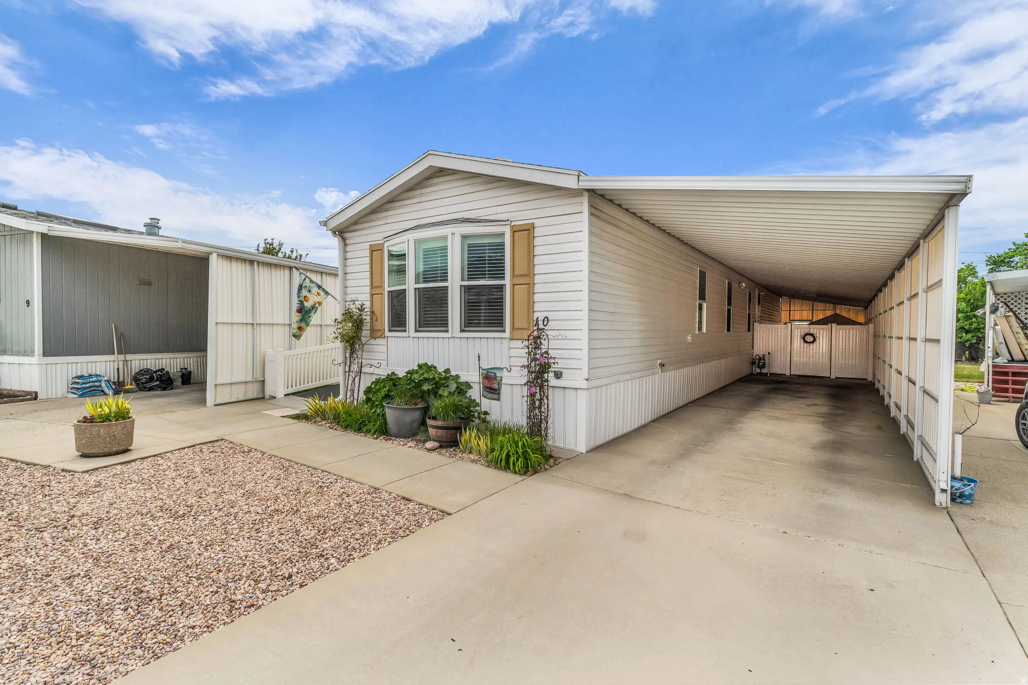 View of front of house with a carport and driveway