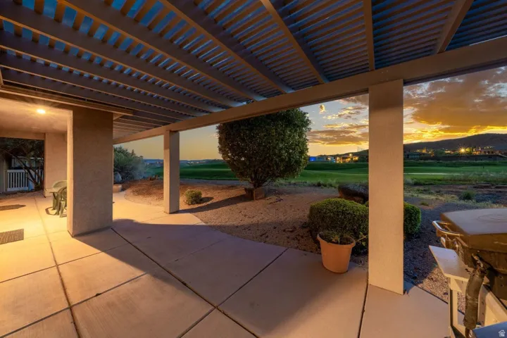 Patio terrace at dusk featuring a patio and a pergola