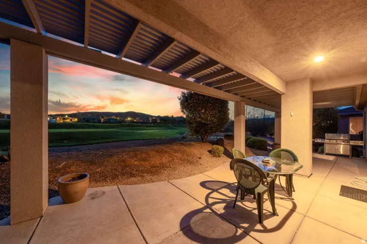 View of patio / terrace with grilling area, view of golf course, and outdoor dining space